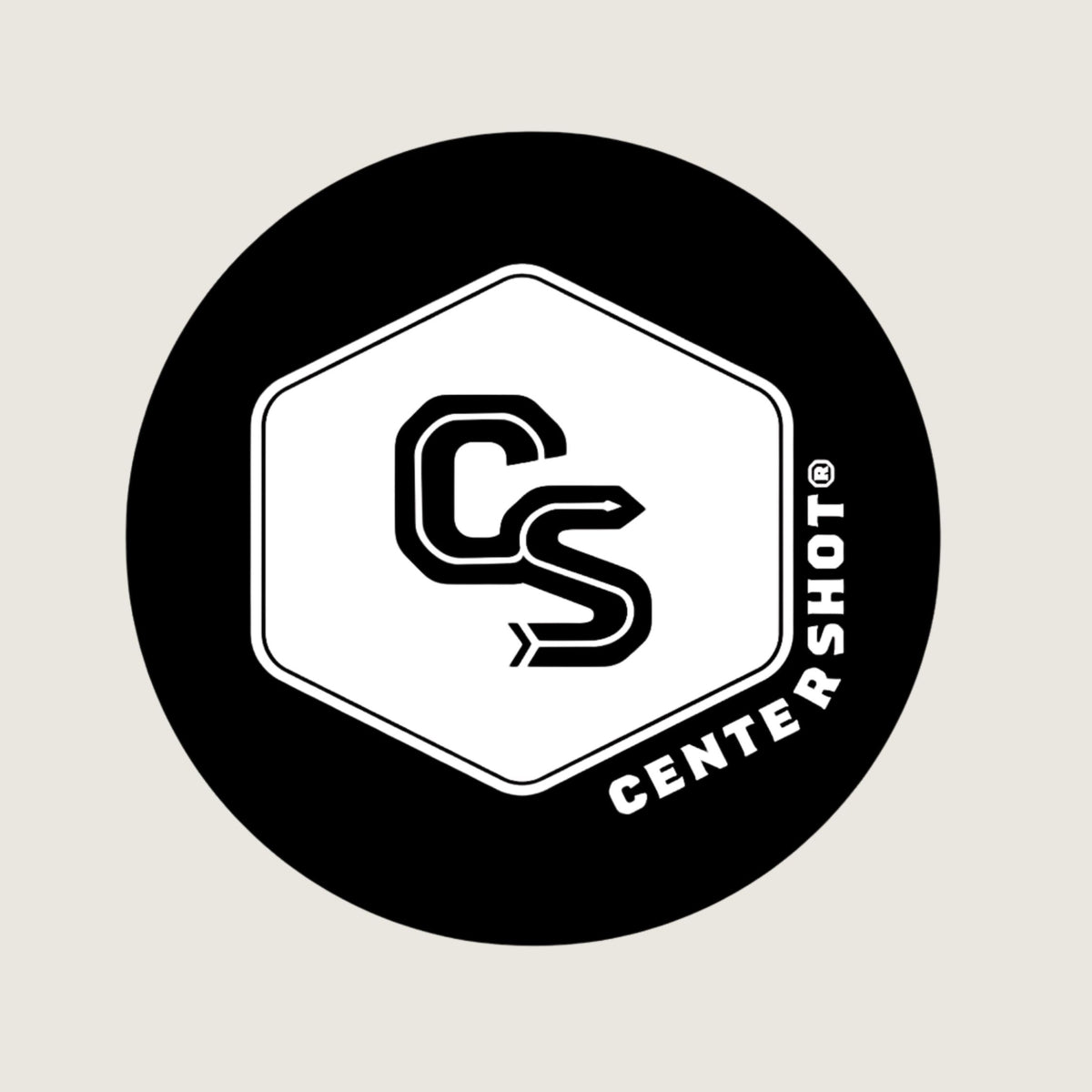 A circular black and white logo featuring a stylized 'CS' monogram inside a hexagon, with the text 'CENTERSHOT' along the lower right edge, centered on a light beige background.